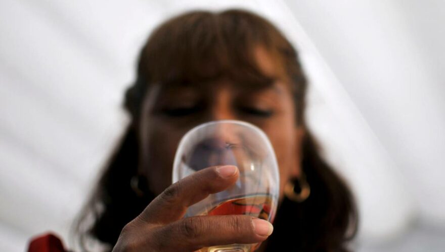 Mujer tomando una copa de vino de diferentes viñas